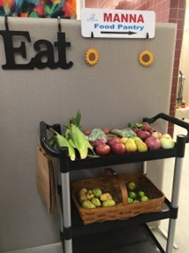 A cart with fresh produce against a wall with 